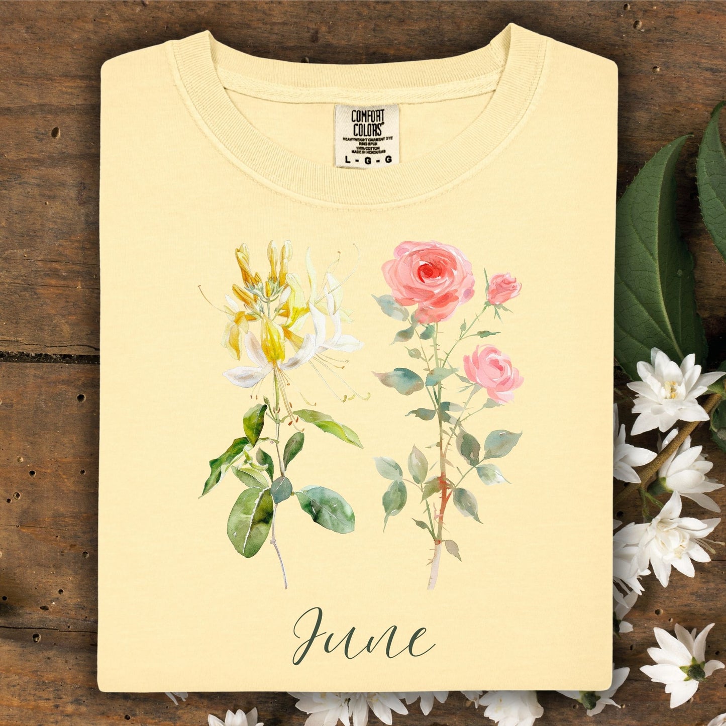 Butter yellow cotton t-shirt with watercolor honeysuckle, pink roses, and "June" lettering.