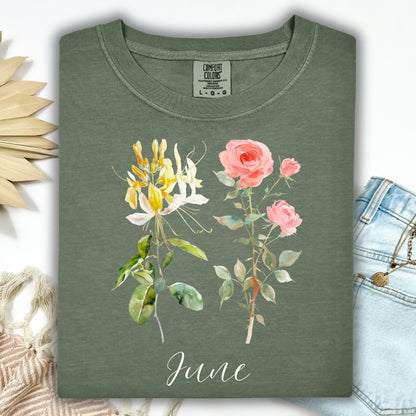 Moss green garment-dyed t-shirt with watercolor honeysuckle, rose, and "June" lettering.