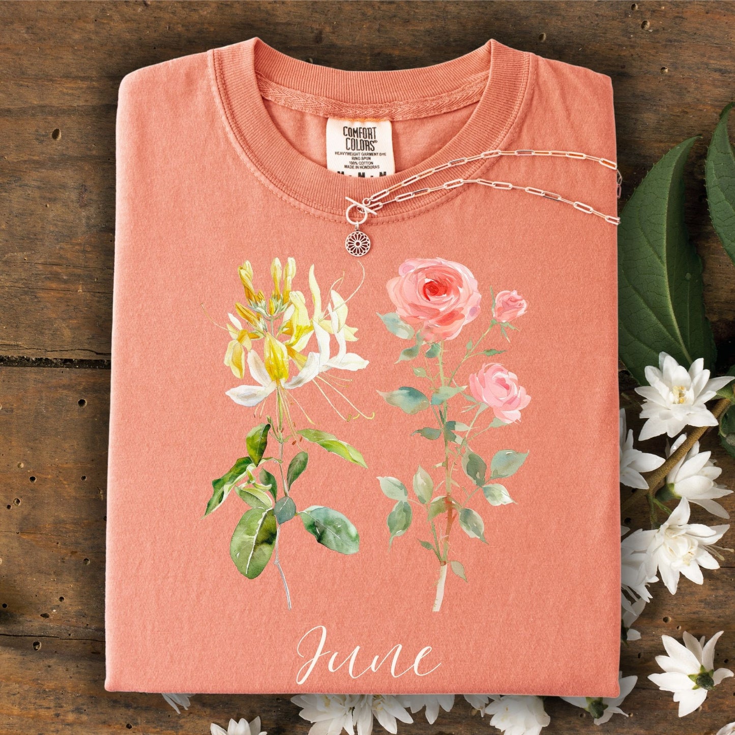 Terracotta June birth month flower t-shirt with honeysuckle, rose, and "June" script, 100% cotton.