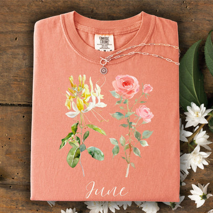 Terracotta June birth month flower t-shirt with honeysuckle, rose, and "June" script, 100% cotton.