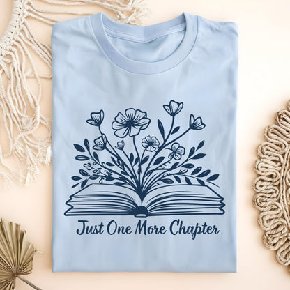 Light blue "Just One More Chapter" t-shirt with a vintage book and wildflowers design.