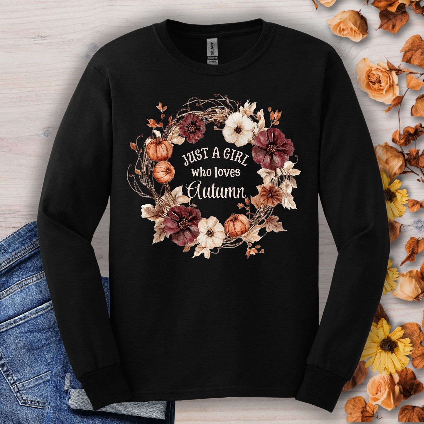 Black Gildan long sleeve tee with a watercolor autumn wreath of pumpkins and flowers, "Just a Girl who loves Autumn" text.