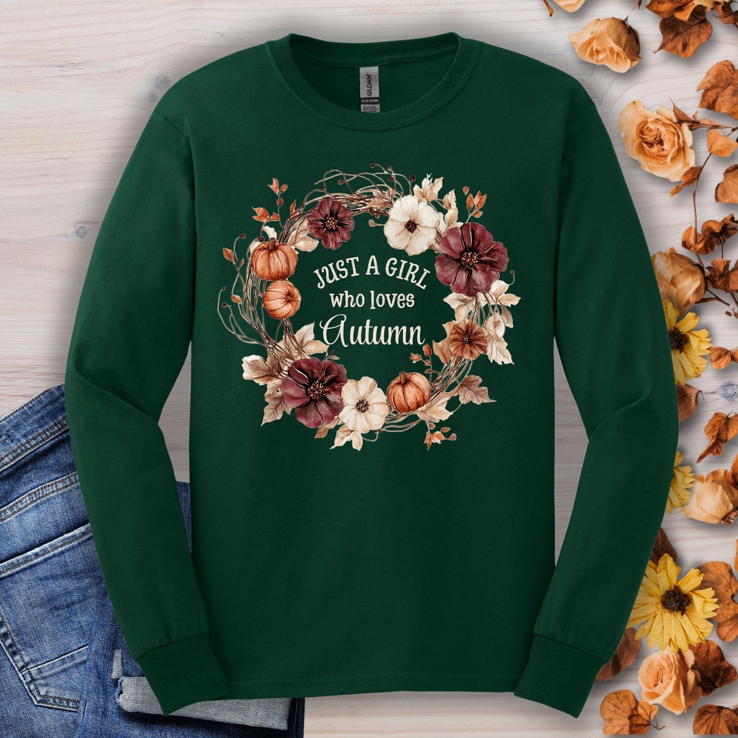Forest Green long sleeve tee with a watercolor autumn wreath of pumpkins and flowers, "Just a Girl who loves Autumn" text.