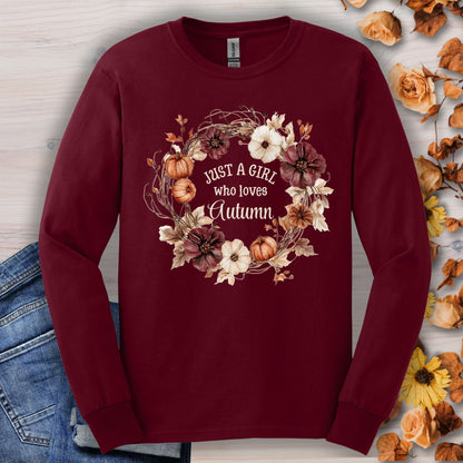 Maroon long sleeve tee with "Just a Girl who loves Autumn" in a watercolor pumpkin and flower wreath.