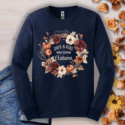 Navy long sleeve tee with a watercolor autumn wreath of pumpkins and flowers, "Just a Girl who loves Autumn" text.