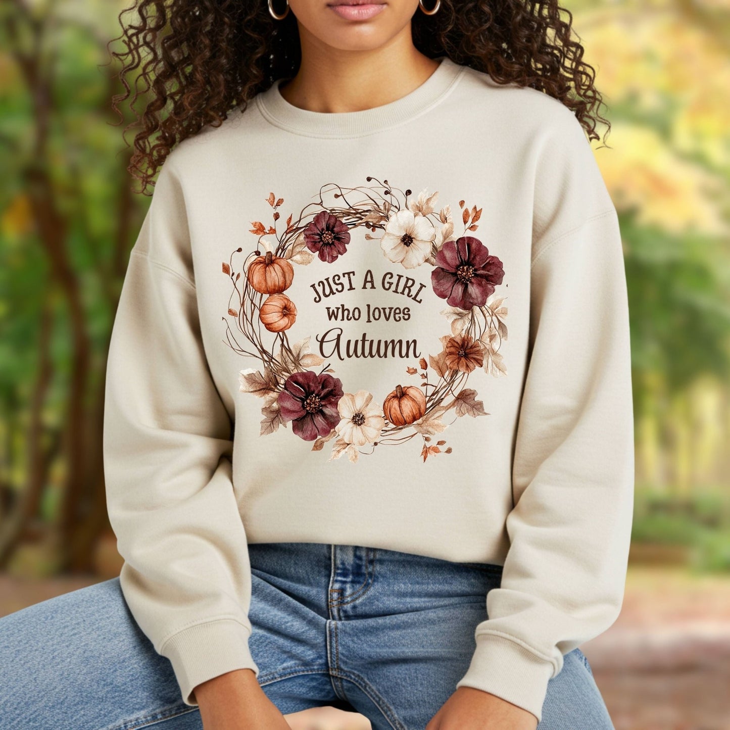 Beige cotton-blend sweatshirt with "Just a Girl who loves Autumn" text in a watercolor floral and pumpkin wreath.