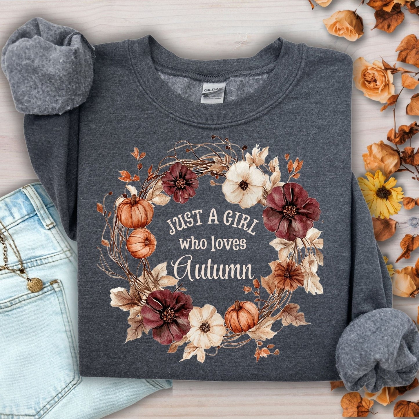 Dark heather cotton-blend sweatshirt with "Just a Girl who loves Autumn" text in a floral pumpkin wreath.