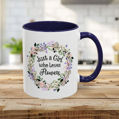 White 11oz mug with "Just a Girl who Loves Flowers" in a watercolor floral wreath, navy interior and handle.
