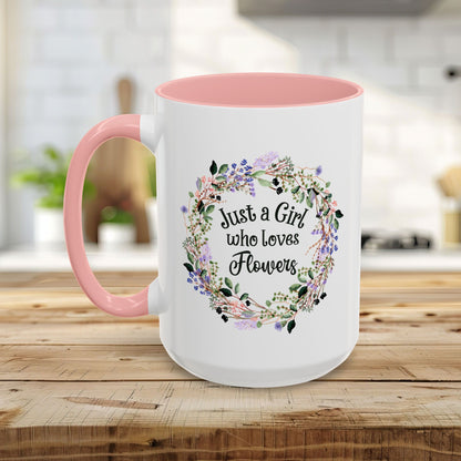 White ceramic mug with pink interior and handle, featuring a watercolor floral wreath and "Just a Girl who Loves Flowers.