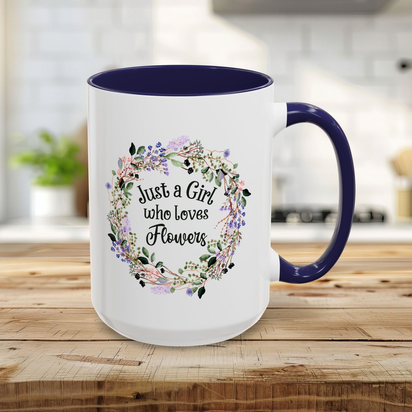 15oz white mug with navy interior/handle, "Just a Girl who Loves Flowers" in a watercolor floral wreath.