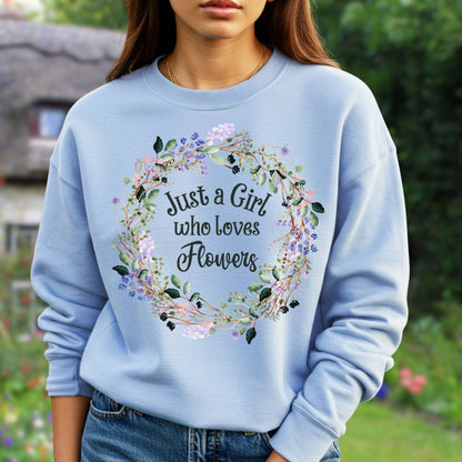 Light blue crewneck sweatshirt with "Just a Girl who loves Flowers" in a delicate floral wreath design.