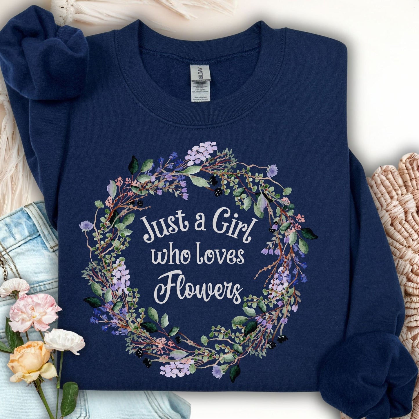 Navy crewneck sweatshirt with "Just a Girl who loves Flowers" in a delicate floral wreath design.