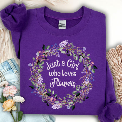 Purple crewneck sweatshirt with "Just a Girl who loves Flowers" in a delicate floral wreath design.