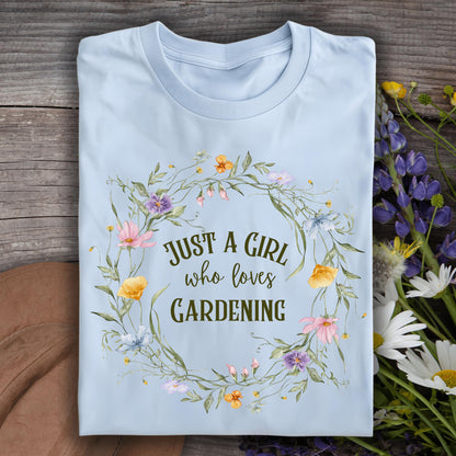 Light blue S t-shirt with "Just a Girl who loves Gardening" text in a wildflower wreath design.