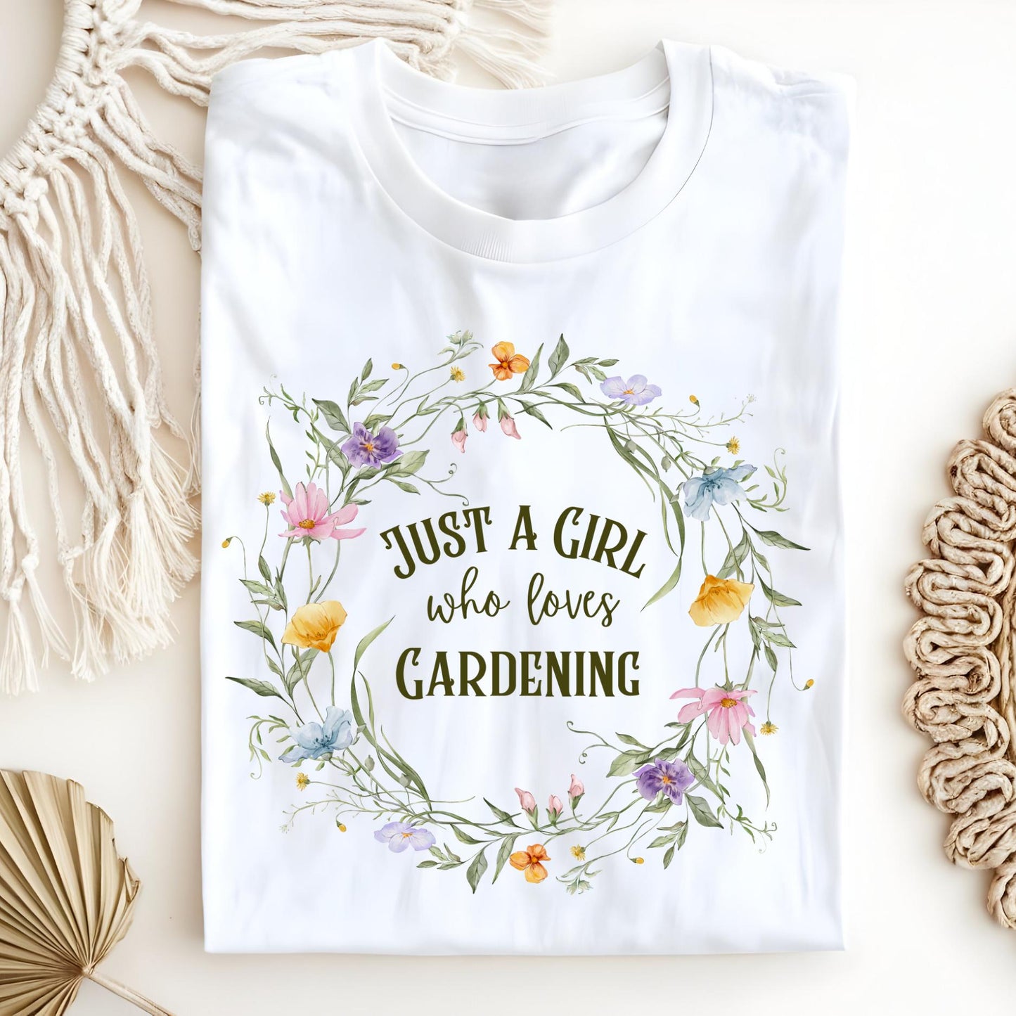White "Just a Girl who loves GARDENING" t-shirt with a colorful wildflower wreath design.