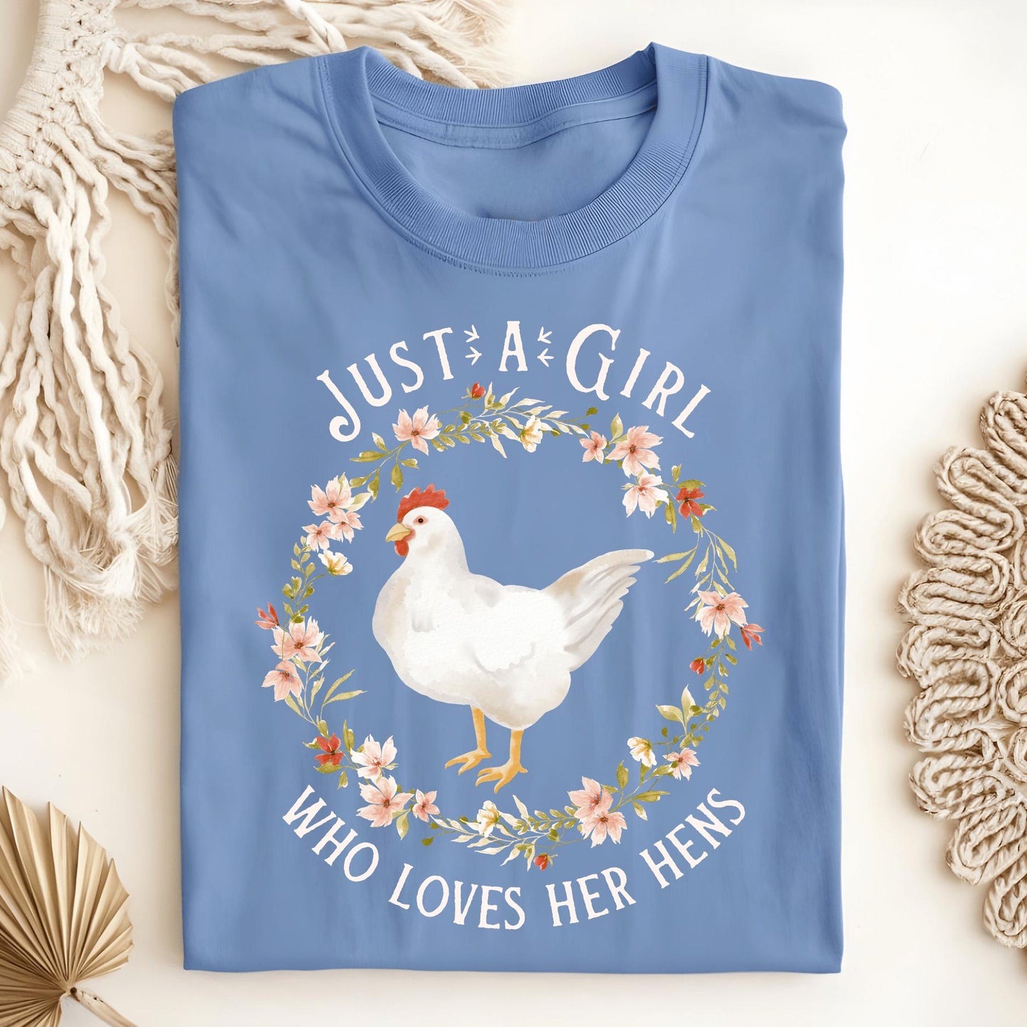 Carolina Blue "Just a Girl Who Loves Her Hens" t-shirt with a white hen in a floral wreath.