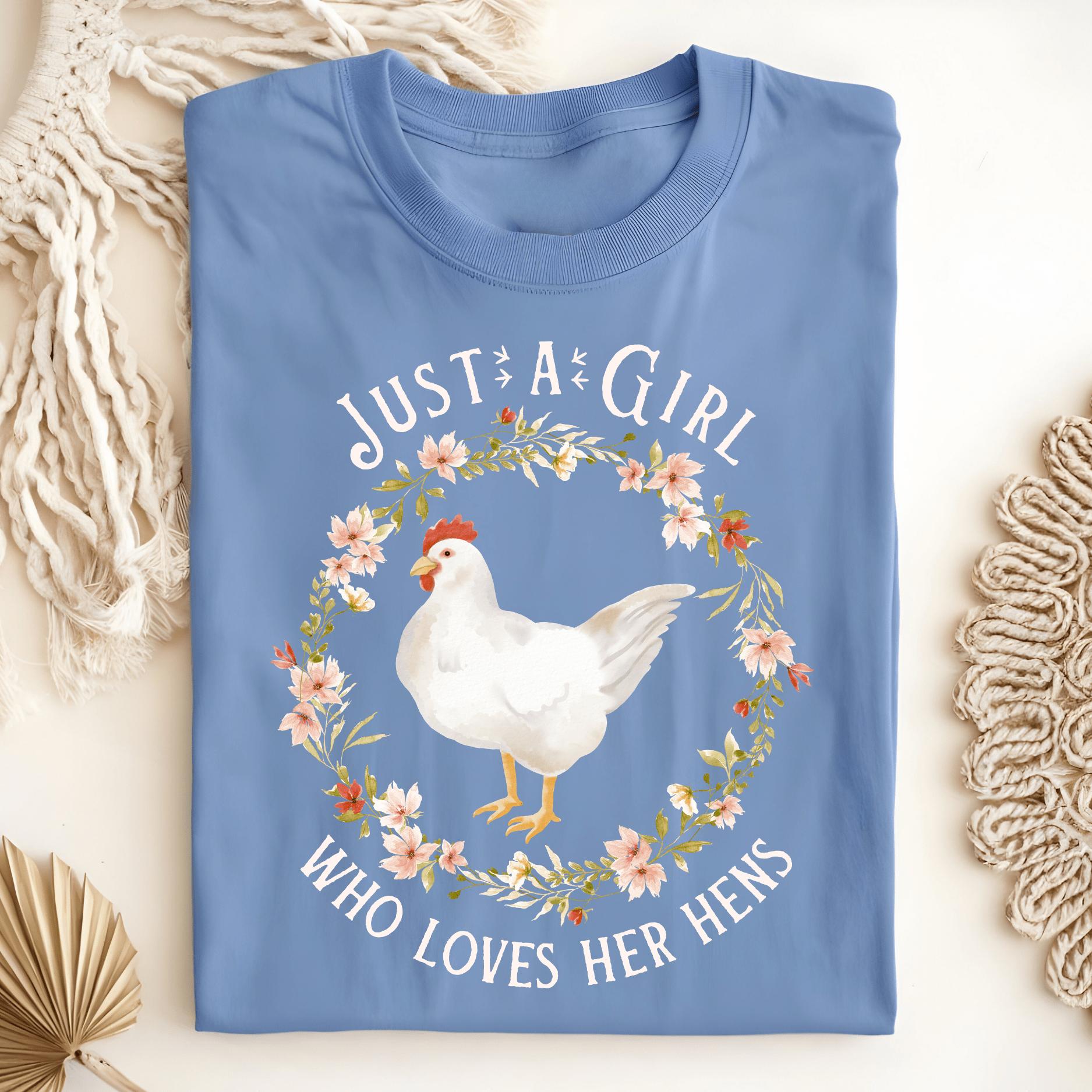 Carolina Blue "Just a Girl Who Loves Her Hens" t-shirt with a white hen in a floral wreath.