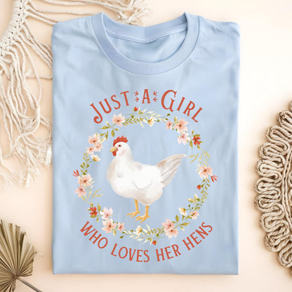 Light blue S t-shirt with "Just a Girl Who Loves Her Hens" text and a white hen in a floral wreath.