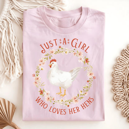 Light pink "Just a Girl Who Loves Her Hens" t-shirt with a white hen in a floral wreath design.