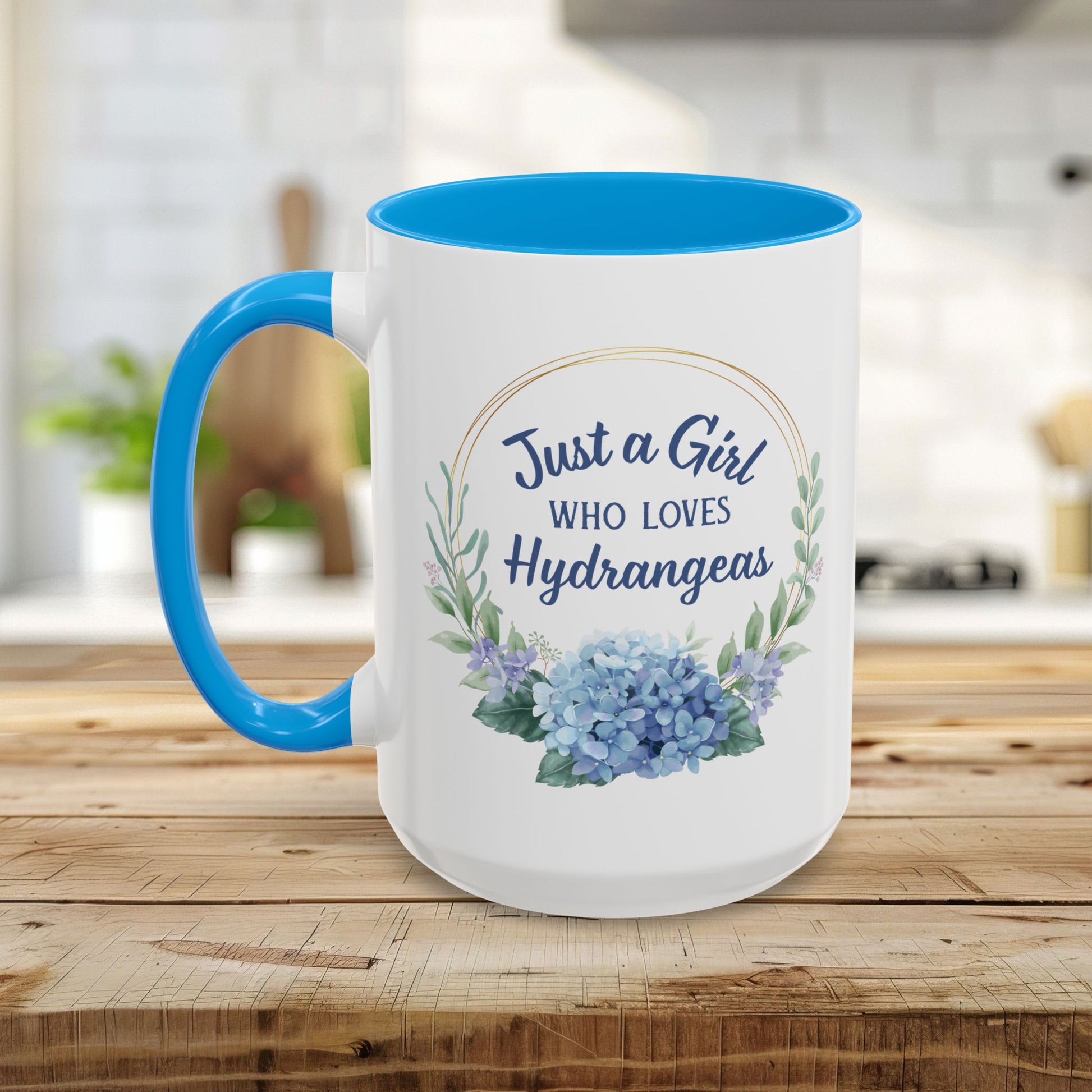 White ceramic mug with blue interior and handle, featuring a watercolor hydrangea wreath and "Just a Girl Who Loves Hydrangeas" text.