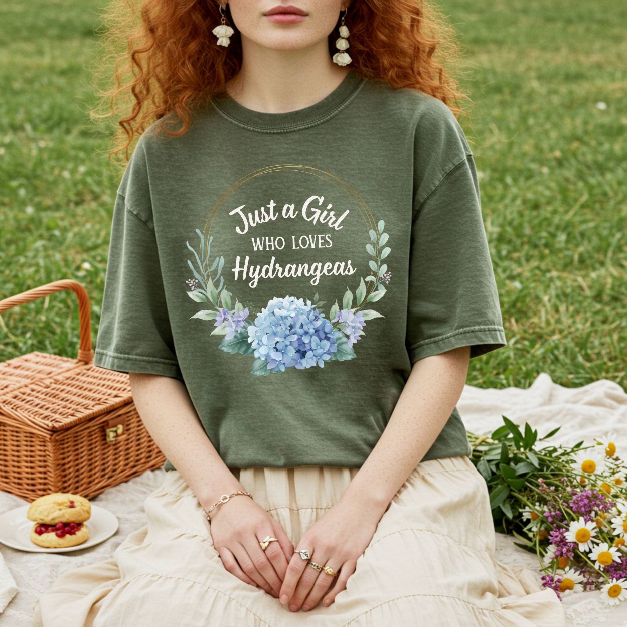 Garment-dyed olive green t-shirt with "Just a Girl Who Loves Hydrangeas" text and a watercolor hydrangea bouquet.