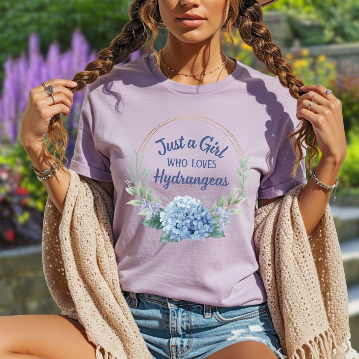 Lavender garment-dyed cotton t-shirt with "Just a Girl Who Loves Hydrangeas" text and a watercolor hydrangea bouquet.