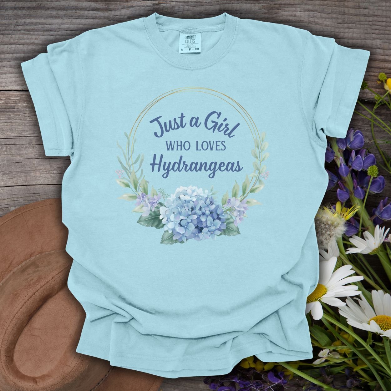 Chambray blue cotton t-shirt with "Just a Girl Who Loves Hydrangeas" text and a watercolor floral design.