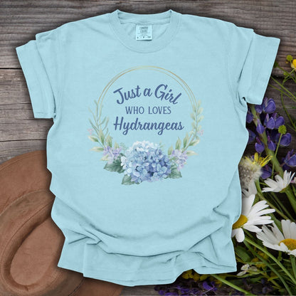 Chambray blue cotton t-shirt with "Just a Girl Who Loves Hydrangeas" text and a watercolor floral design.