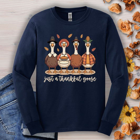 Navy long sleeve tee with pilgrim ducks, pumpkin pie, and "just a thankful goose" text.