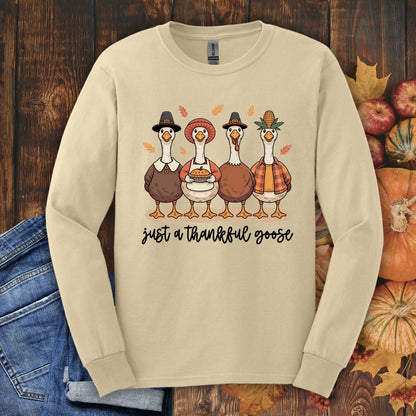 Sand long sleeve tee with "Just a Thankful Goose" text and four pilgrim ducks eating pie.