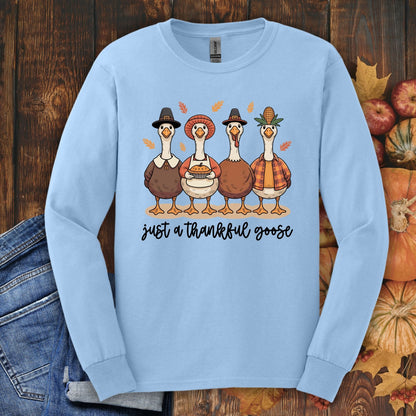 Light blue long sleeve tee with "Just a Thankful Goose" text and four pilgrim ducks.