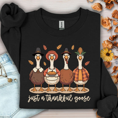 Black cotton-polyester sweatshirt with four pilgrim ducks, autumn leaves, and "just a thankful goose" text.