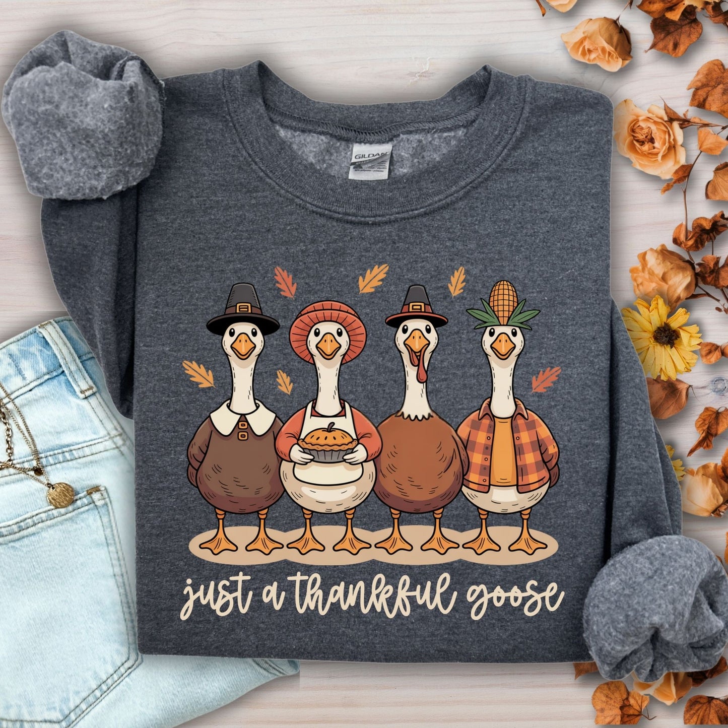 Dark Heather S sweatshirt with pilgrim ducks, apple pie, and "just a thankful goose" text.