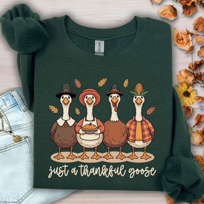 Forest Green heavy blend sweatshirt with pilgrim ducks, apple pie, and "Just a Thankful Goose" text.