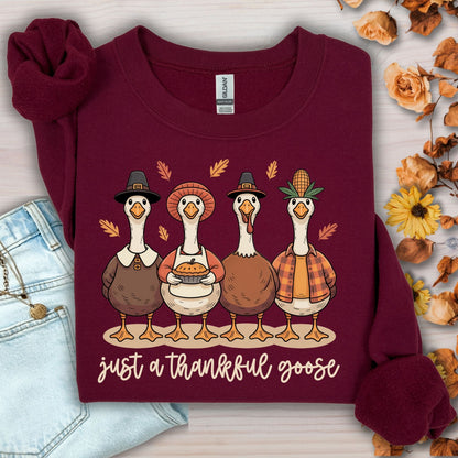 Maroon Gildan heavy blend sweatshirt with four pilgrim ducks, apple pie, and "just a thankful goose" text.