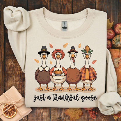 Sand S heavy blend sweatshirt with "Just a Thankful Goose" and pilgrim ducks enjoying apple pie.