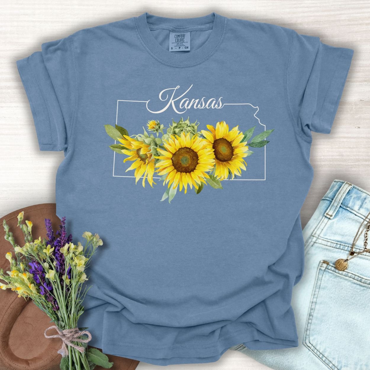 Blue Jean Kansas State Flower T-shirt with golden sunflowers and state outline, made from soft, garment-dyed cotton.