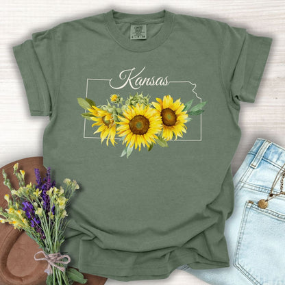 Moss green cotton t-shirt with a Kansas outline, "Kansas" script, and golden sunflowers.