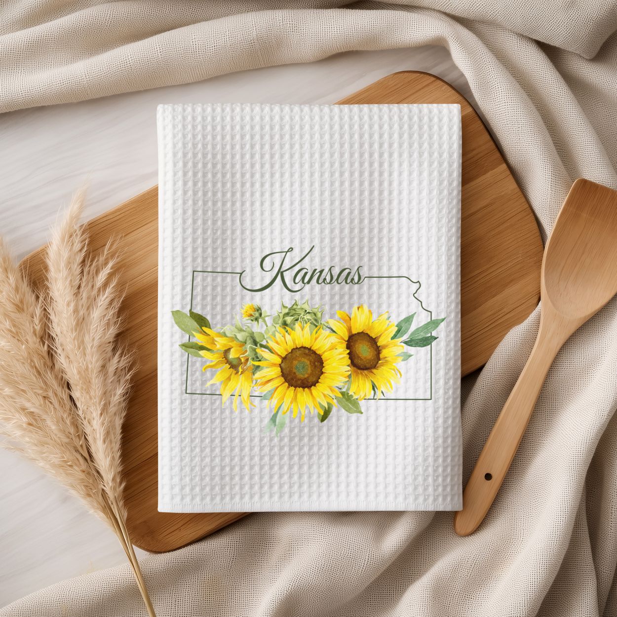 White microfiber tea towel with vibrant Kansas sunflower design and state outline.