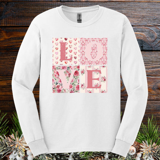 White long-sleeve tee with "LOVE" in pink patchwork, featuring hearts and floral patterns.