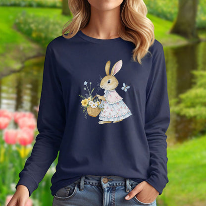 Woman in navy long sleeve tee with a watercolor lady bunny in a floral dress holding a spring flower basket.
