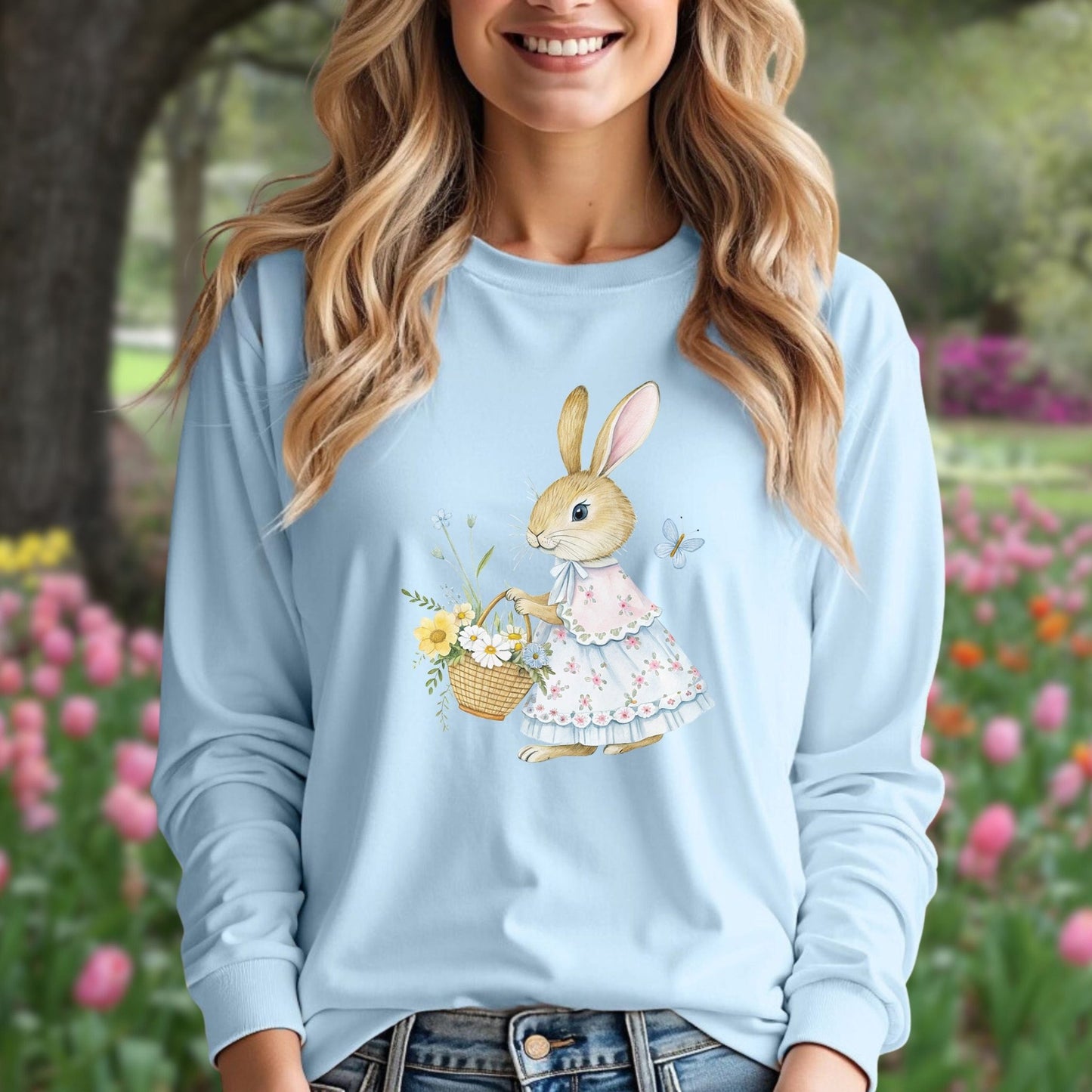 Light blue long-sleeve tee with a watercolor lady bunny in a floral dress holding a flower basket.