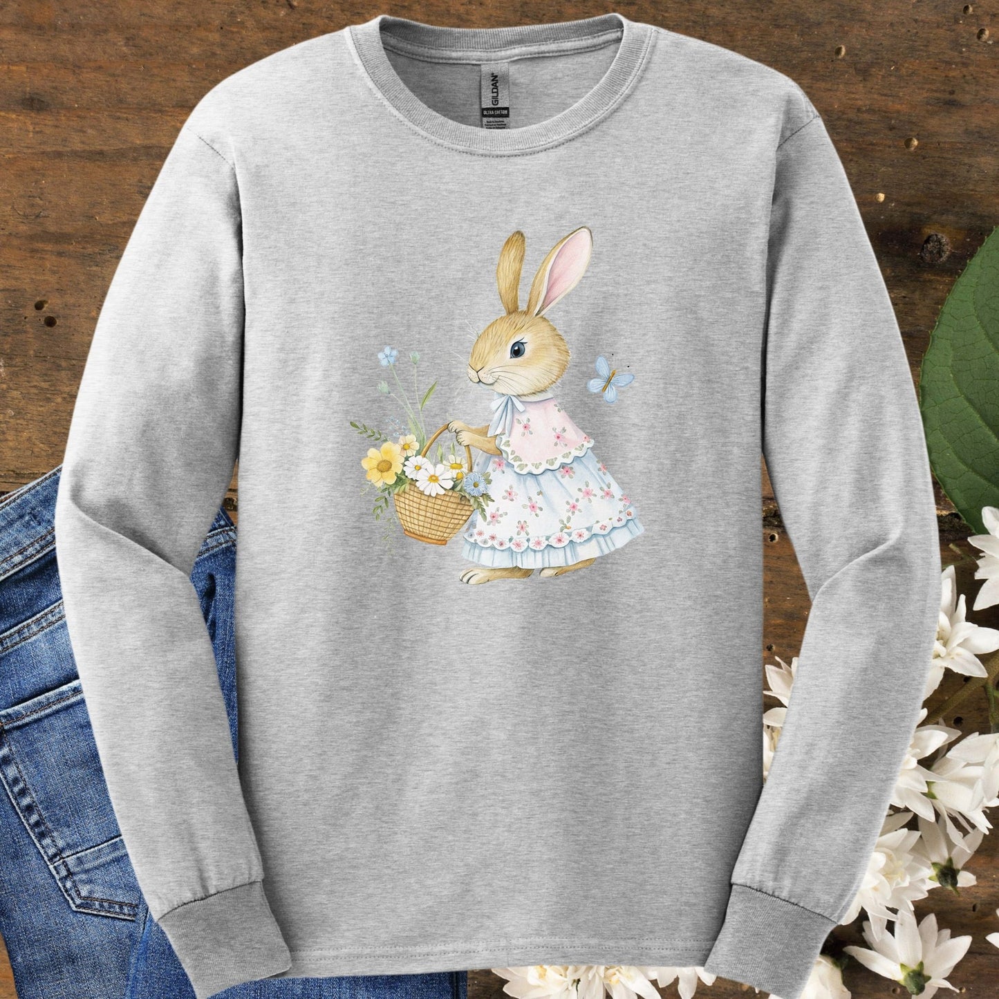 Ash long sleeve tee with watercolor lady bunny in floral dress holding a flower basket.
