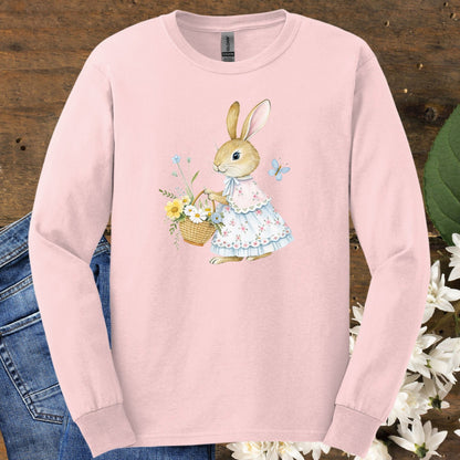 Light pink long-sleeve tee with a watercolor lady bunny in a floral dress holding a spring flower basket.