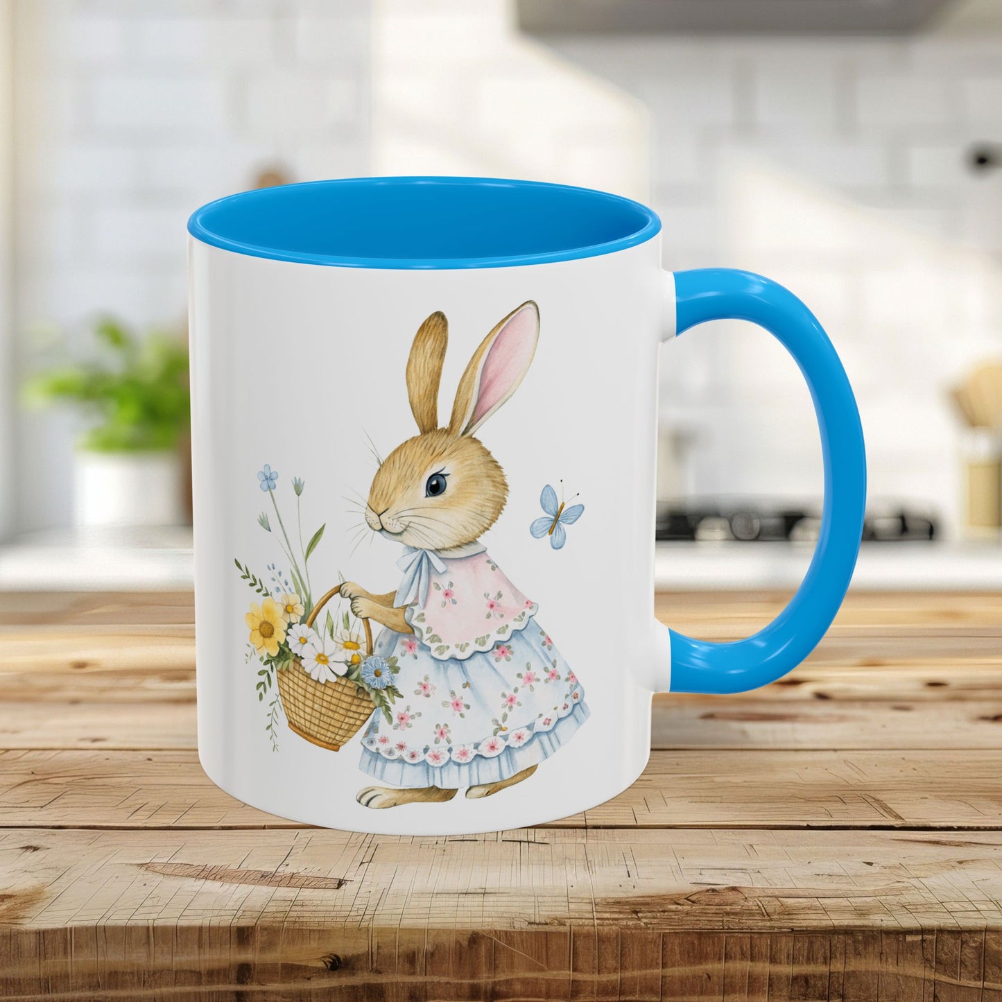 11oz white mug with light blue interior/handle, featuring a watercolor bunny in a frilly dress holding a flower basket.