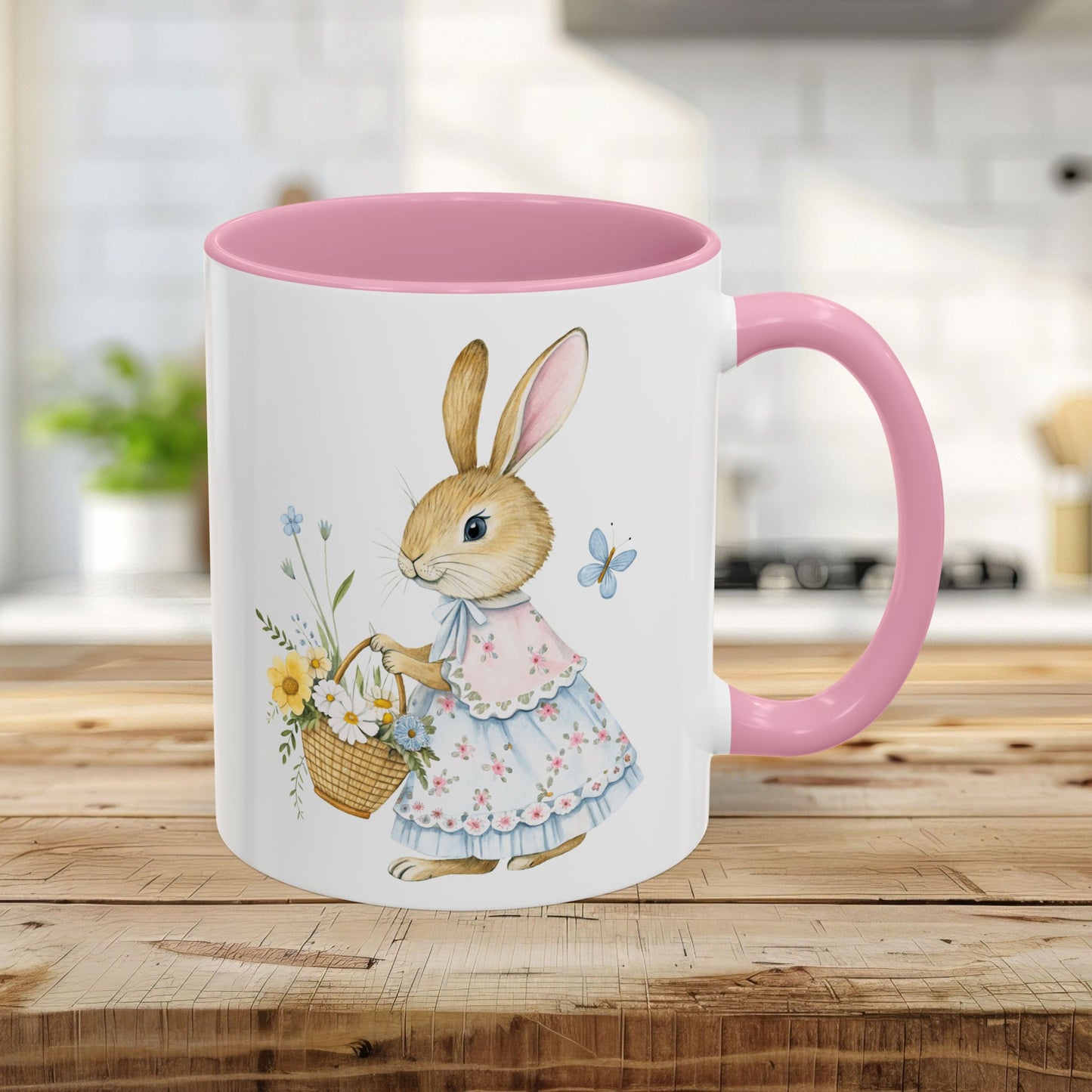 White 11oz mug with a pink interior/handle, featuring a watercolor bunny in a floral dress holding a flower basket.