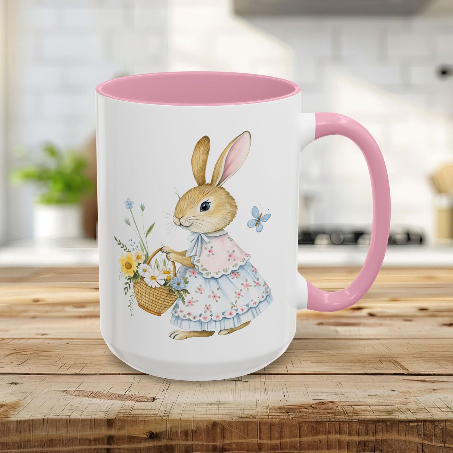 15oz white ceramic mug with a pink interior/handle, featuring a watercolor bunny in a floral dress holding a flower basket.