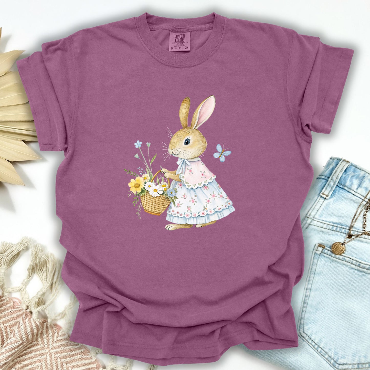Berry S t-shirt with a watercolor bunny in a floral dress holding a flower basket.