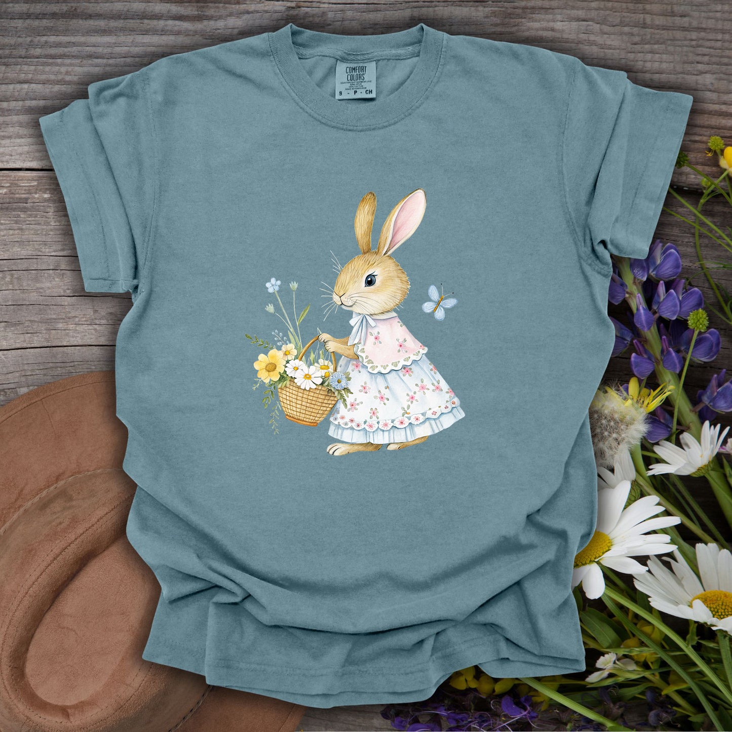Ice Blue S t-shirt with a watercolor bunny in a floral dress holding a flower basket.