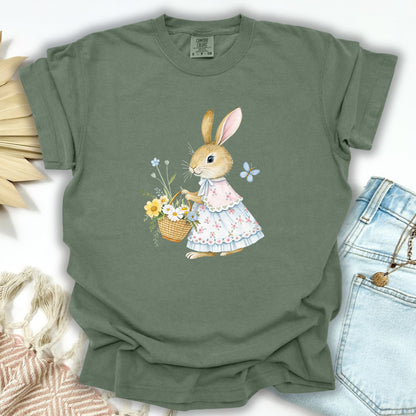 Moss green S-size cotton tee with a watercolor bunny in a floral dress holding a flower basket.